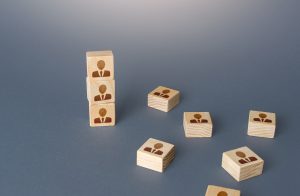 Blocks with professional person silhouette on the front with a blue/grey background